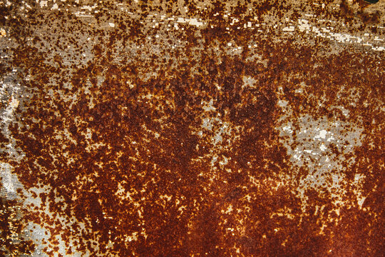 Heavy rust texture with flaking white paint on a metal surface