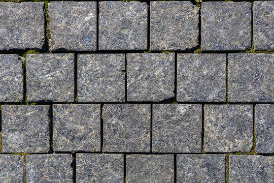 Dark granite cobblestone pavement texture background