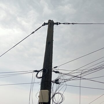The sturdy concrete utility poles are equipped with an intricate network of cables and junction boxes for the city's telecommunications infrastructure and power grid.