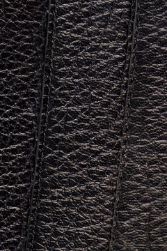 details of a natural black leather bag after prolonged use, dark color