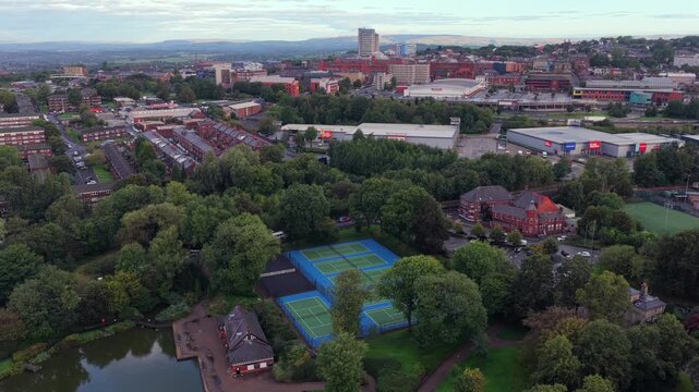Aerial video of Alexandra Park Boating Lake Tennis Courts and Oldham Town Skyline