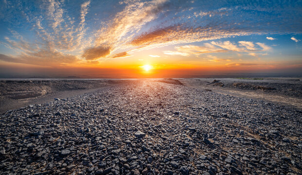 Sunset over the desolate Gobi Desert landscape in Xinjiang, China