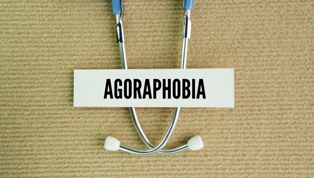 Stethoscope and paper tag with the word Agoraphobia is an anxiety disorder characterized by an intense fear and avoidance of situations where escape might be difficult or help unavailable if panic sym