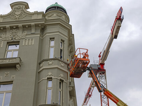 Telehandler Aerial Work Platform Maintenance Elevated Work at Hotel Building Exterior.