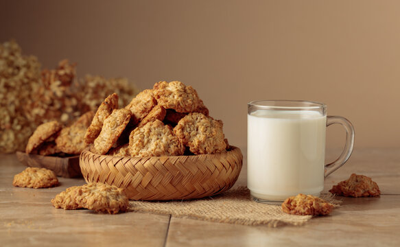 Oatmeal cookies and milk on a kitchen table.