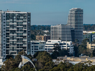 Contemporary residential towers clustered in northwest Sydney, with modern apartments and high rise housing in a growing commercial precinct in northwest Sydney, Australia © Paul Tama