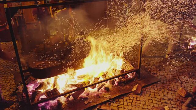  Roasting chestnuts on an open fire in the streets of Portugal, popular autumn street food in Europe and Asia.