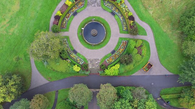 Aerial Top-Down Video of Alexandra Park Circular Ornamental Fountain and Flowerbeds in Oldham, Greater Manchester. 