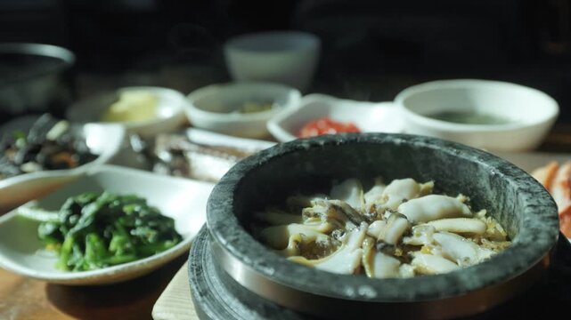 Sliced Abalone Served In A Stone Bowl, Traditional Seafood Dish In Jeju Island, South Korea. Close-up Shot