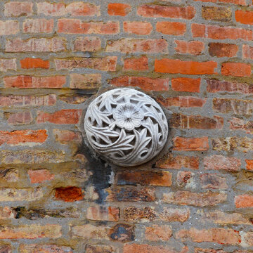 Medieval art in Venice. Stone flower with leaves old relief on a wall
