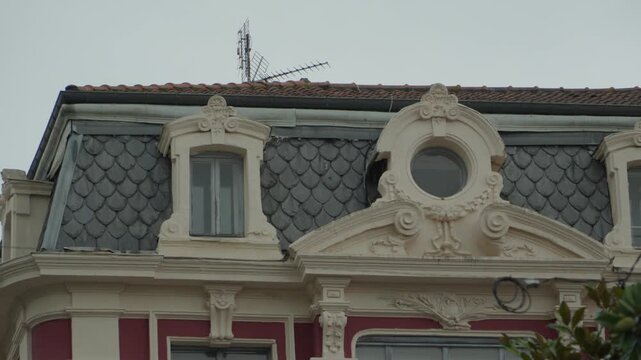 Decorative dormer windows and ornate roofing on a historic building