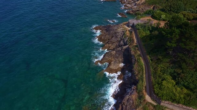 Forward drone fly over the rugged Horn of the Ghoul headland or Cor de la Goule aux Fees where the sea waves hitting the rocky Dinard coastline, Ille‑et‑Vilaine, France