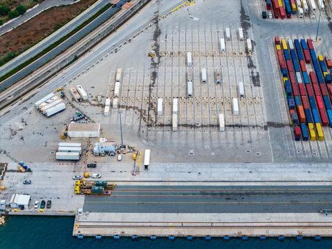 Aerial view of the container terminal at Limassol Port with rows of colorful shipping containers, parked trucks, and industrial infrastructure in Lemesos, Lemesos, Cyprus.
