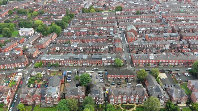 Aerial video of Oldham Terraced Housing Townscape and Pennine Hills Horizon in Greater Manchester. 