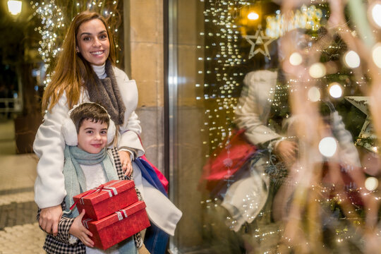 Mother and son enjoying christmas shopping with gifts