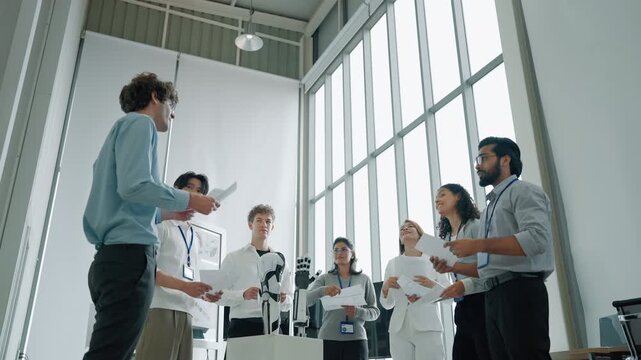 A diverse engineering team discussing a humanoid robot prototype during a technology presentation, representing robotics research, automation, artificial intelligence, and future innovation.
