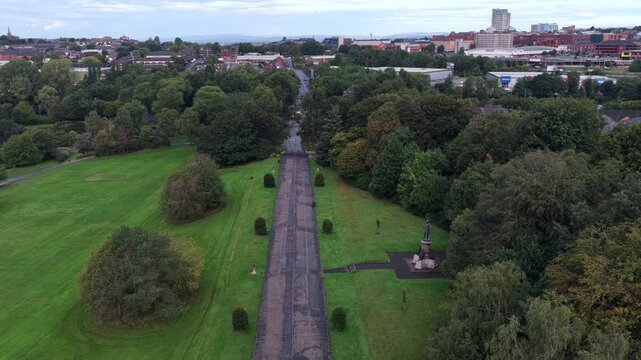 Aerial video of Alexandra Park Central Promenade and Oldham Town Skyline in Greater Manchester. 