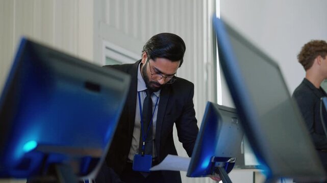 Engineering professional working at a computer workstation in a modern technology environment, representing research, software development, data analysis, and technical innovation.
