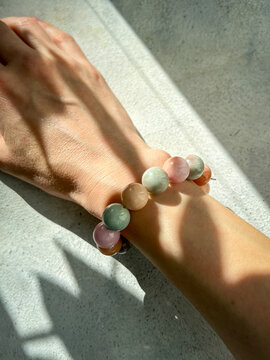 Elegant female hand wearing quartz stone bracelet in soft natural light - luxury jewelry fashion detail with timeless beauty aesthetic