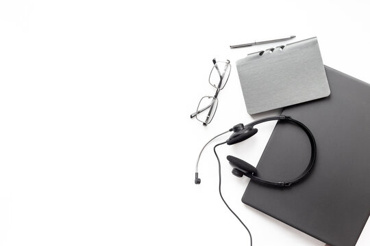 Call center and online communication desk setup - modern home office flat lay with laptop and headset