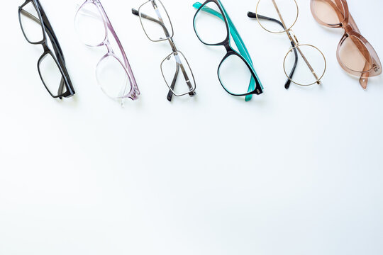 Glasses for vision with different frame and lenses on a white background, top view