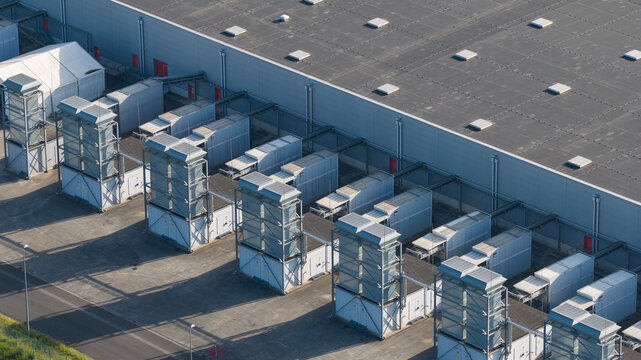 Aerial view of the Google data center featuring rows of industrial cooling units and a large warehouse roof in Saint-Ghislain, Region wallonne, Belgium.