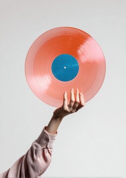Hand holding vibrant vinyl record.