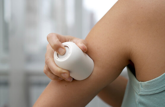 Woman Applying Continuous Glucose Monitor CGM Sensor to Arm