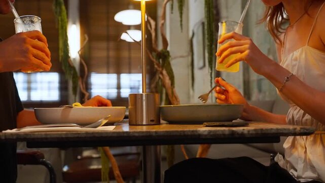 Romantic couple clinking glasses during dinner date