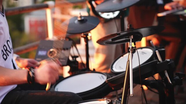 Drummer's hands playing electronic drum kit