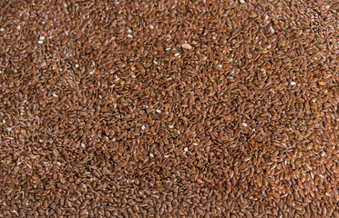 Pile of raw whole  organic linen seed texture background