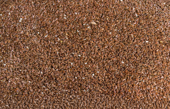 Pile of raw whole  organic linen seed texture background