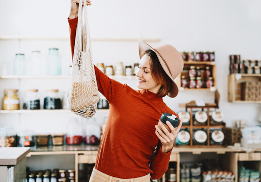 Young woman in zero waste shop or plastic free store.