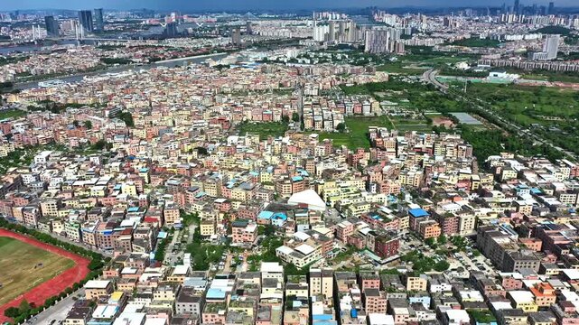 Aerial View of Dense Colorful Urban Cityscape with Residential Buildings and Green Fields