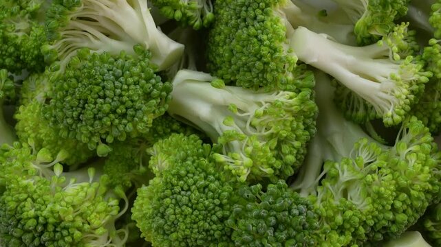 Closeup of fresh broccoli florets rotating top view. Green vegetable.