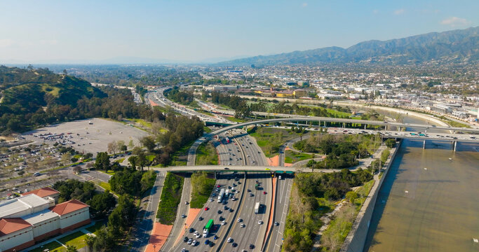 Aerial view of the busy highway interchange and Los Angeles River flowing through the urban landscape of Los Angeles, California, United States.