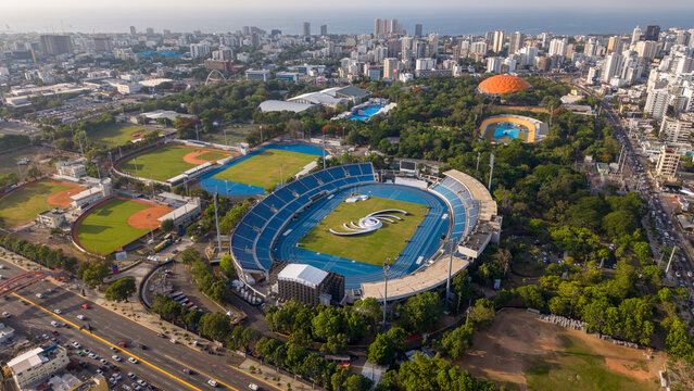 Aerial view of the Centro Olimpico Juan Pablo Duarte sports complex with its stadium, running track, and baseball fields in Santo Domingo, Distrito Nacional, Dominican Republic.