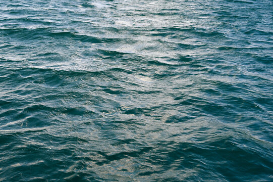 Ocean Water Surface with Waves and Sunlight Reflections