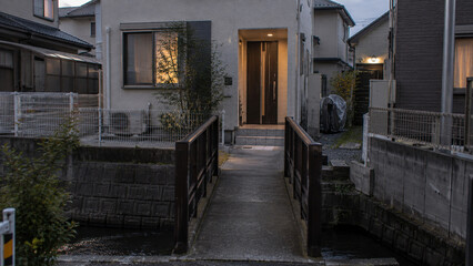 Fototapeta premium Modern Japanese House with a Small Canal in a Quiet Neighborhood