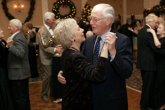Cheerful seniors slow dancing at holiday gala