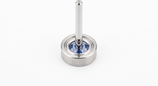 Synthetic sapphire jewel bearing and stainless steel spindle for anemometer cup shaft. Low-friction internal pivot for wind speed measurement hardware, isolated on white.