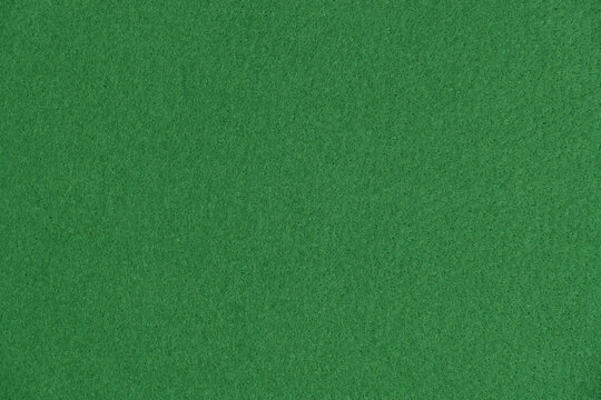 Green felt fabric texture background close up view