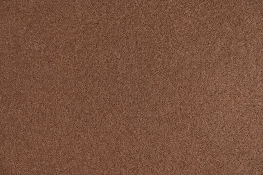 Brown felt fabric texture background close up view