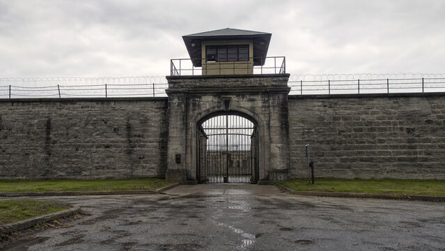 Imposing stone prison wall establishing shot