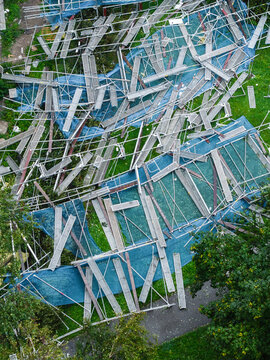 Aerial view of collapsed scaffolding from a building renovation project scattered across the grass in Purvciems, Riga, Latvia.