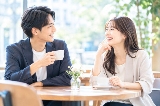 カフェで会話を楽しむ男女、自然な出会いと交流をイメージした明るいカジュアルシーン
