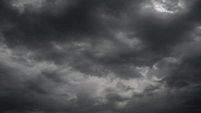 Dark Stormy Sky with Heavy Ominous Clouds and Faint Sunlight
