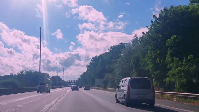 Driving on a motorway with a view from a car on a sunny day