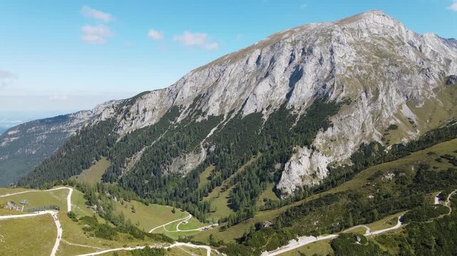 Aerial drone view from Jenner mountain near Sch&ouml;nau am K&ouml;nigssee, Germany, flying over scenic hiking trails, alpine meadows and forests surrounded by the majestic Berchtesgaden Alps.
