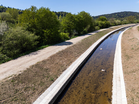 A river restoration project aimed at flood prevention and channel widening in a green landscape.